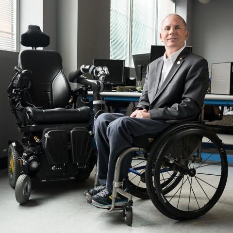 Dr Rory Cooper pictured next to the wheelchair he designed