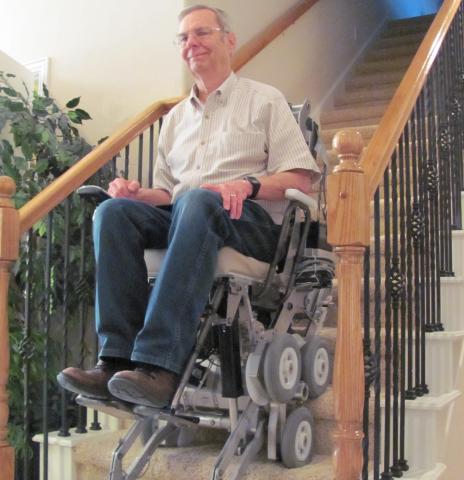 Senior Caucasian male sitting on wheelchair on home stairs